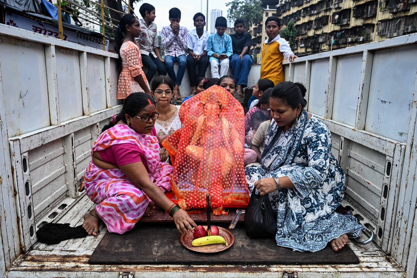 People carry Ganesh idols to their respective homes on the occasion of Ganesh Chaturthi festival, at Lalbaug