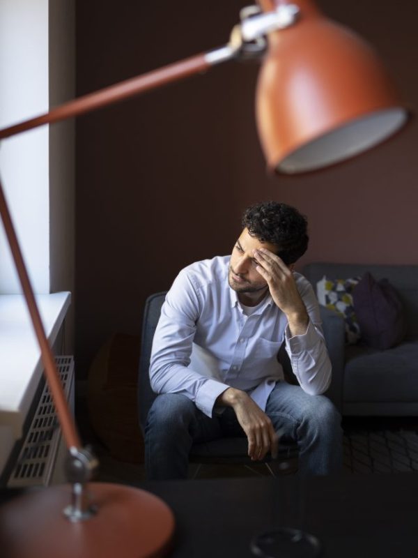 anxious-man-indoors-full-shot