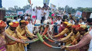 Tribal instruments including trumpets accompany the protest march in Nashik