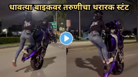 Girl performing dangerous bike stunt on highway