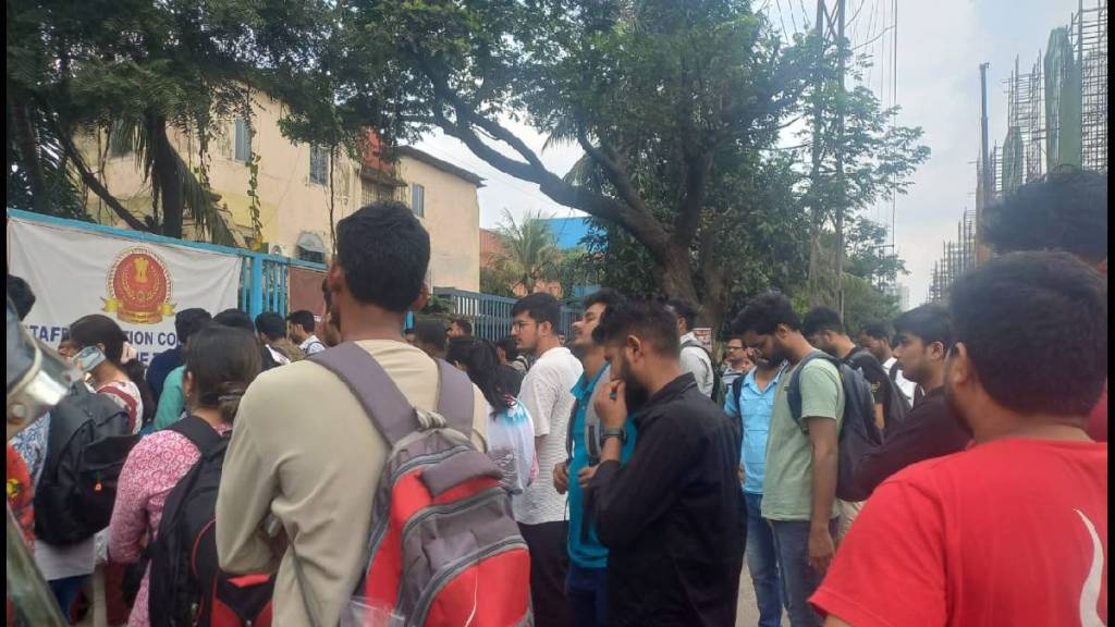 Students and parents standing on the main road in Dombivli MIDC for the staff selection exam.