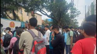 Students and parents standing on the main road in Dombivli MIDC for the staff selection exam.