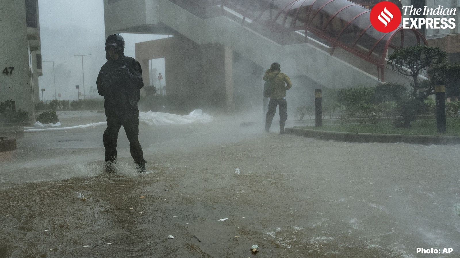 Pedestrians struggle to stay upright against Ragasa’s powerful gusts