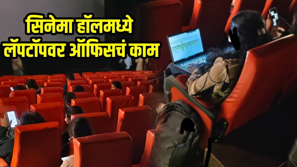 woman spotted working on laptop inside movie theatre