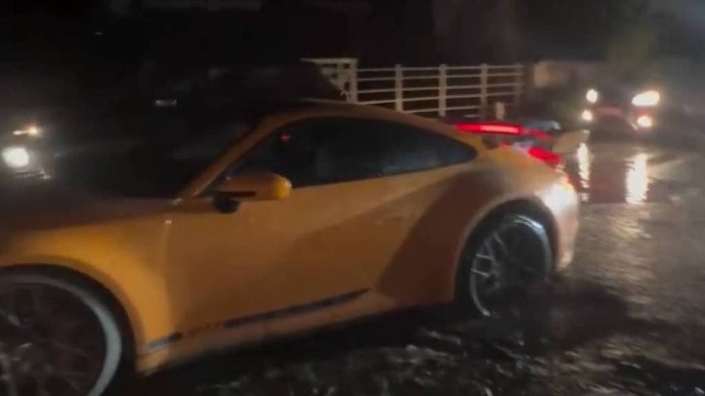 Porsche car-stuck-in-pothole