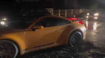 Porsche car-stuck-in-pothole