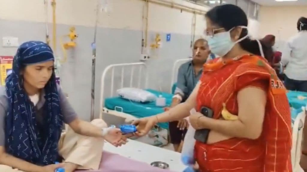 bjp worker takes back biscuit packet after taking photo in rajasthan jaypur video goes viral