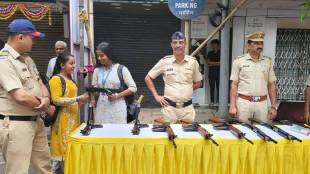 Two college girls admiringly handle a police carbine gun on Phadke Road