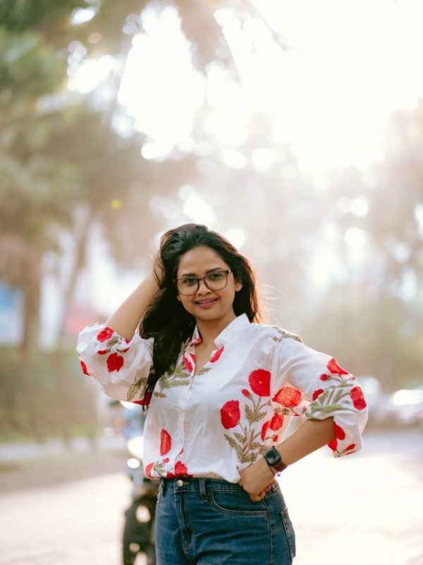 Apoorva Gore posing with her black car.