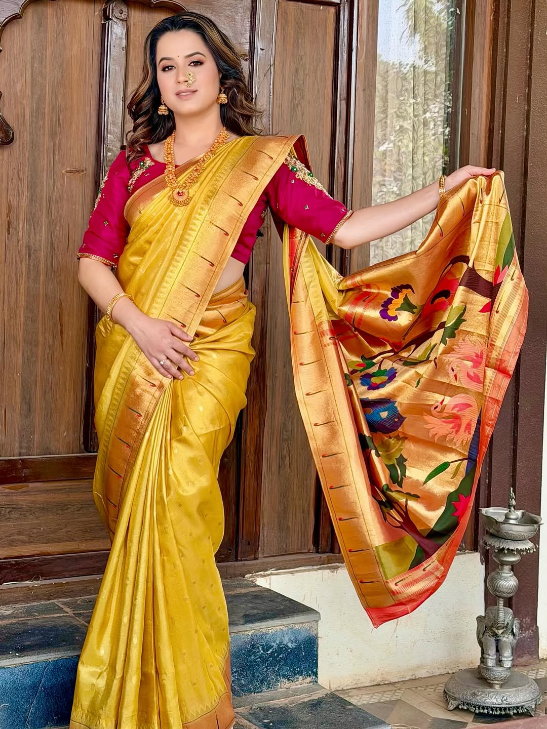 Prajakta Gaikwad in pink Banarasi saree with traditional jewelry.