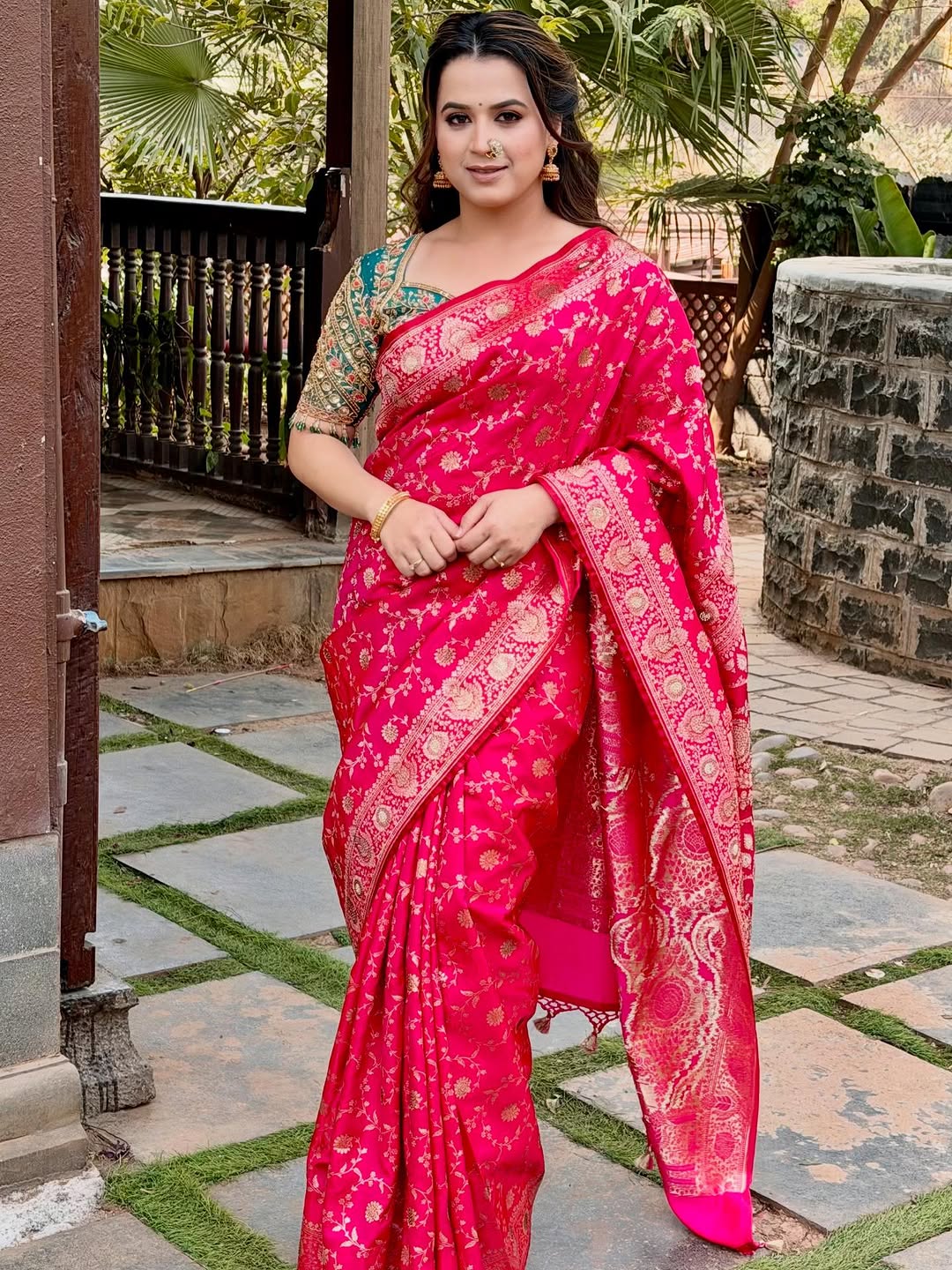 Prajakta Gaikwad in pink Banarasi saree with traditional jewelry.