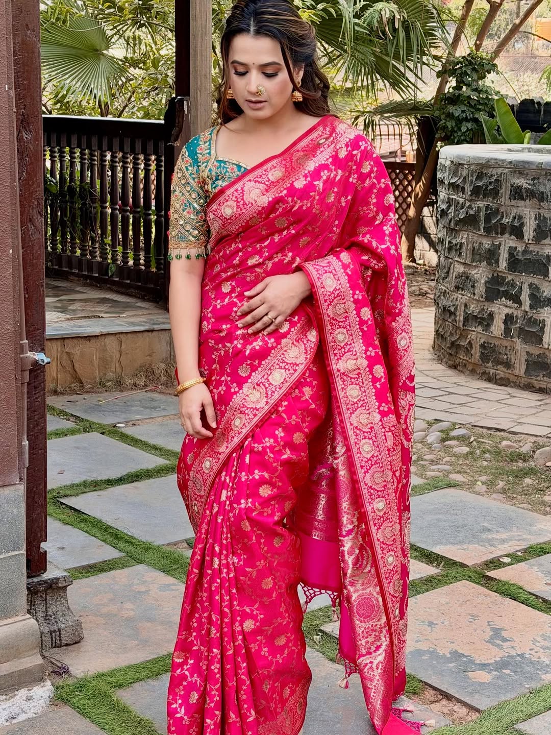 Prajakta Gaikwad in pink Banarasi saree with traditional jewelry.