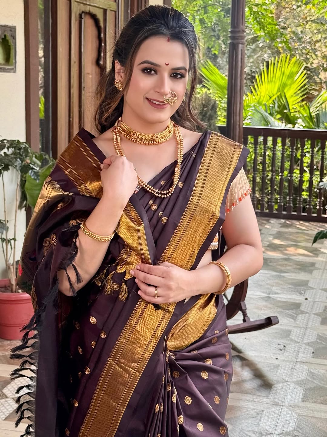 Prajakta Gaikwad in pink Banarasi saree with traditional jewelry.