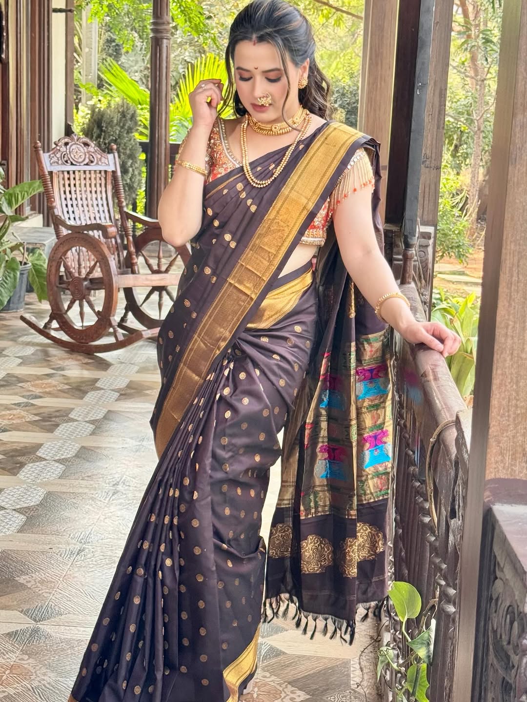Prajakta Gaikwad in pink Banarasi saree with traditional jewelry.