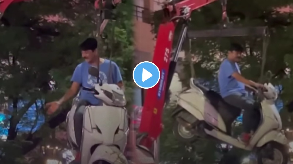 Man clings to scooter as towing crane lifts it into the air viral video sparks debate.
