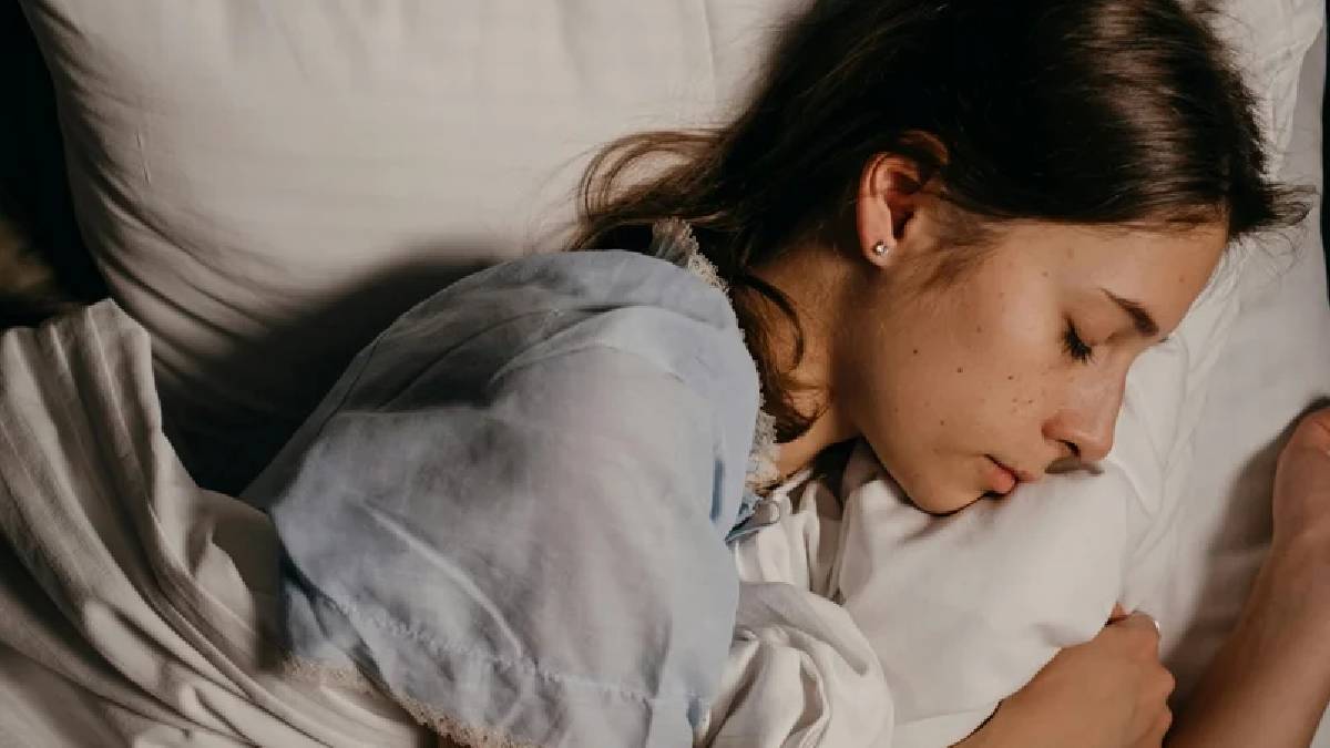 Woman sleeping peacefully, symbolizing why women need more sleep