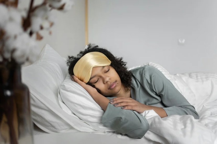 Woman sleeping peacefully, symbolizing why women need more sleep