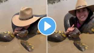 woman kissing anaconda in river video