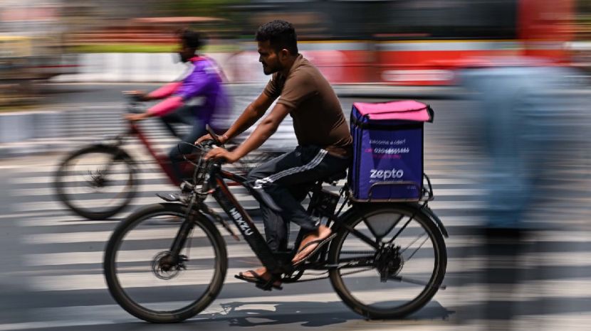 Gig workers are seen on their way to deliver orders