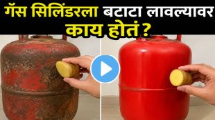 Woman applying potato on gas cylinder base to remove rust stains from kitchen floor