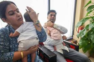 Rahul and Meena Rathore with kids, who filed complaint against IVF center, in New Delhi on Friday. (Express Photo: Praveen Khanna)