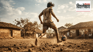 Young football player dribbling a ball on a dusty village ground with traditional rural houses and spectators in the background.
