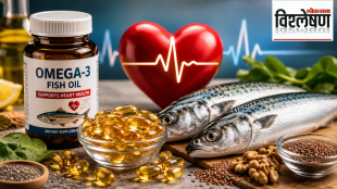 A bottle of omega-3 fish oil gel capsules alongside a fresh salmon fillet on a wooden board