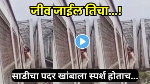 Woman hanging from the footboard of a crowded Mumbai local train near Diva Mumbra
