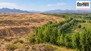 A realistic landscape showing a barren, eroded region transitioning into a lush green tree belt and cultivated farmland, symbolising large-scale ecological restoration and the Great Green Wall.