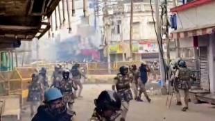 Security personnel disperse tear gas shells following stone-pelting incidents during protests against the proposed removal of a portion of the 'Shahi Masjid' for road widening, in Ujjain, Madhya Pradesh, Monday, Sept. 28, 2026. (PTI Photo)