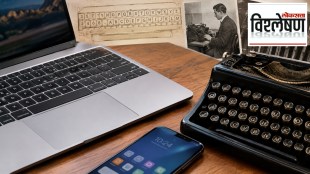 A modern laptop and smartphone placed beside a vintage typewriter, illustrating the evolution of keyboards and the history of the QWERTY layout.